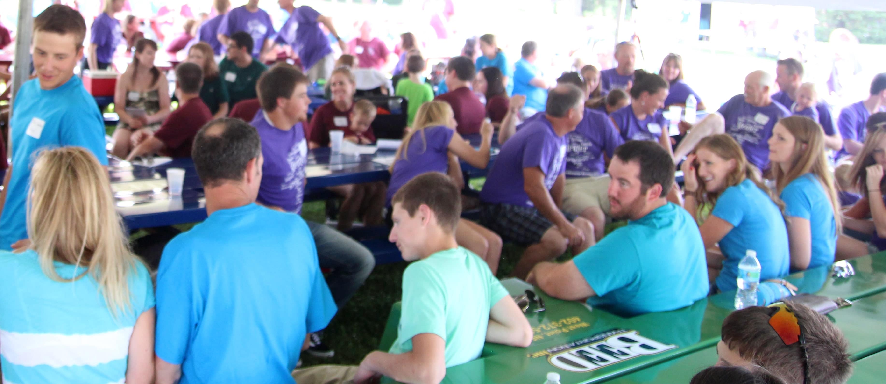 Group of people at an event sitting at trailer tables